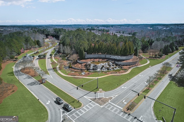 drone / aerial view featuring a forest view