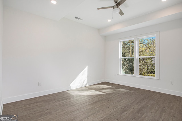 empty room with dark wood-type flooring and ceiling fan