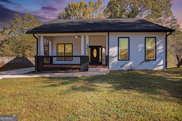 view of front facade featuring a yard and covered porch