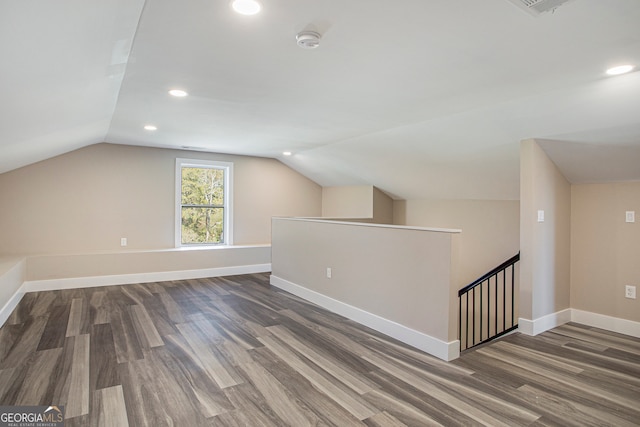 bonus room featuring dark wood-type flooring and lofted ceiling