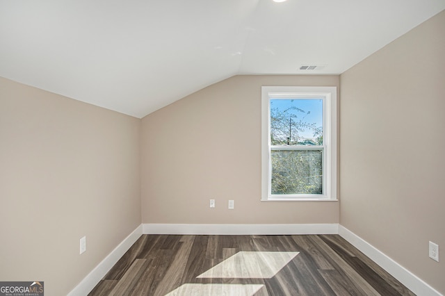 bonus room featuring dark hardwood / wood-style floors and vaulted ceiling