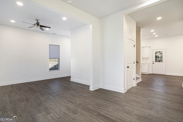 empty room featuring dark wood-type flooring and ceiling fan