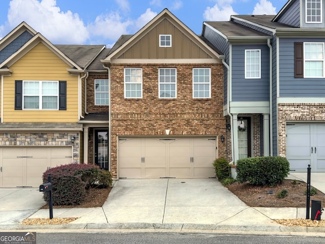 2397 Sardis Chase Ct, Buford, GA 30519 - townhome / multi-family property with a garage, concrete driveway, brick siding, and board and batten siding