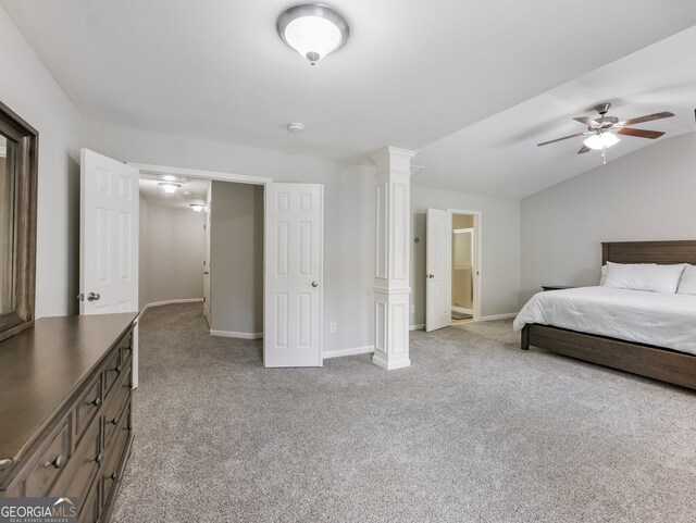 bedroom featuring light carpet, ceiling fan, vaulted ceiling, and decorative columns