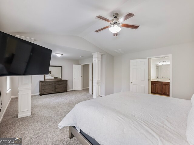 bedroom featuring decorative columns, vaulted ceiling, light carpet, and ceiling fan