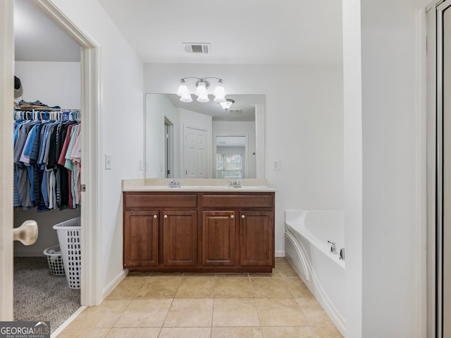 2397 Sardis Chase Ct, Buford, GA 30519 - bathroom with a chandelier, double vanity, a garden tub, tile patterned flooring, and a spacious closet