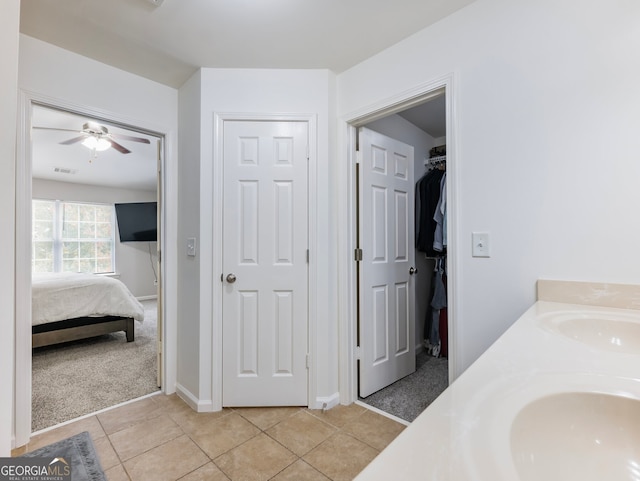 bathroom featuring vanity, ceiling fan, and tile patterned flooring