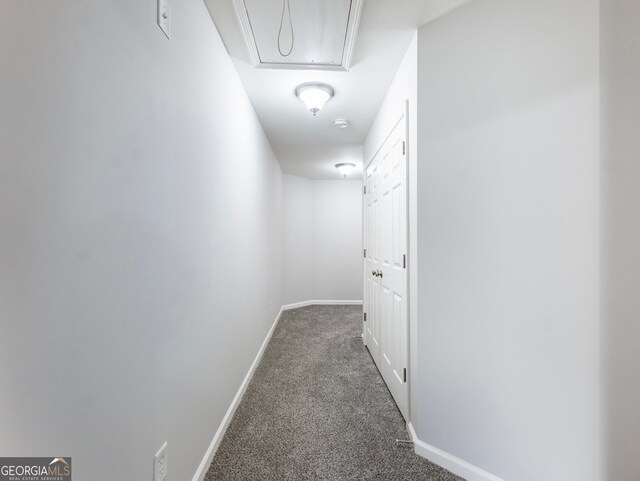 corridor featuring dark carpet