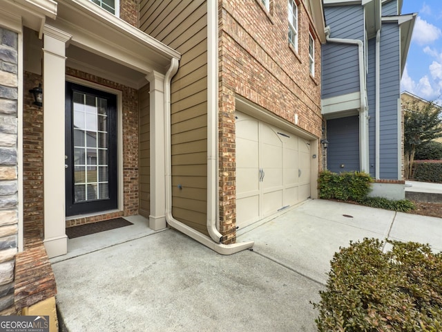 view of exterior entry with a garage