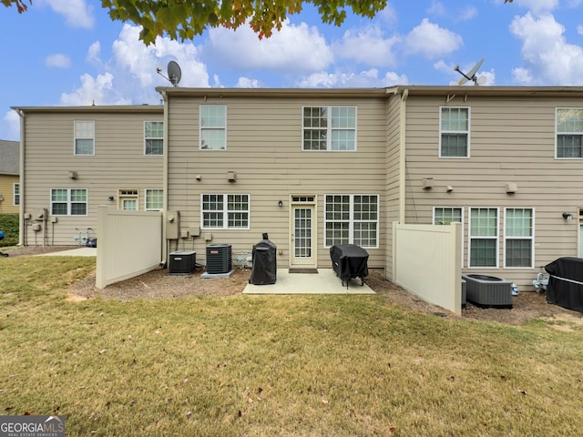 rear view of house featuring a patio, a lawn, and cooling unit