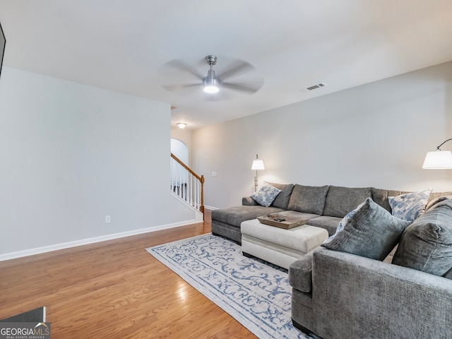 living room featuring ceiling fan and hardwood / wood-style flooring