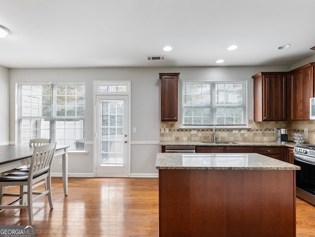 2397 Sardis Chase Ct, Buford, GA 30519 - kitchen with a sink, stainless steel appliances, backsplash, light wood-style flooring, and light stone counters