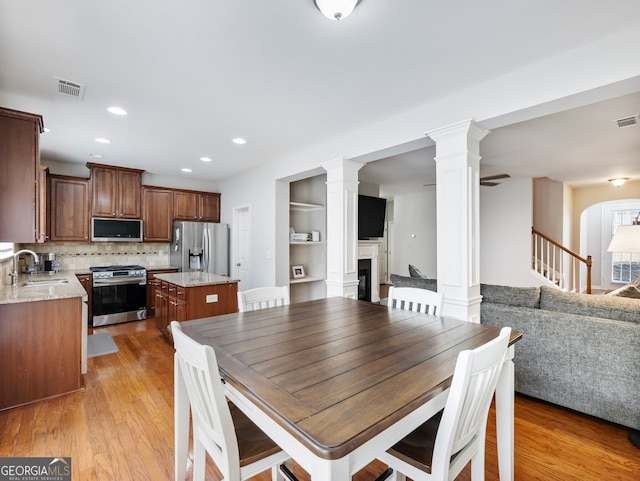 dining area featuring sink and light wood-type flooring