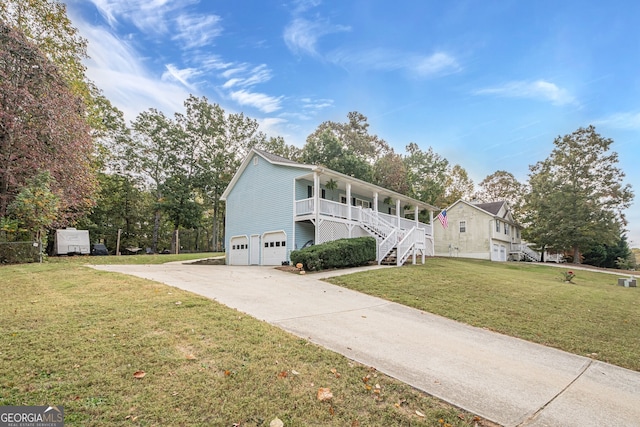 view of front facade with a front lawn, covered porch, and a garage