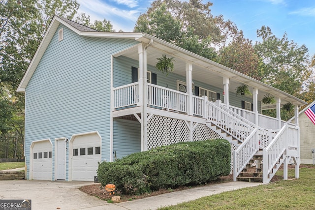 view of side of home with a porch and a garage