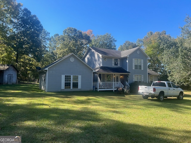 view of front of home featuring a front yard and a storage unit