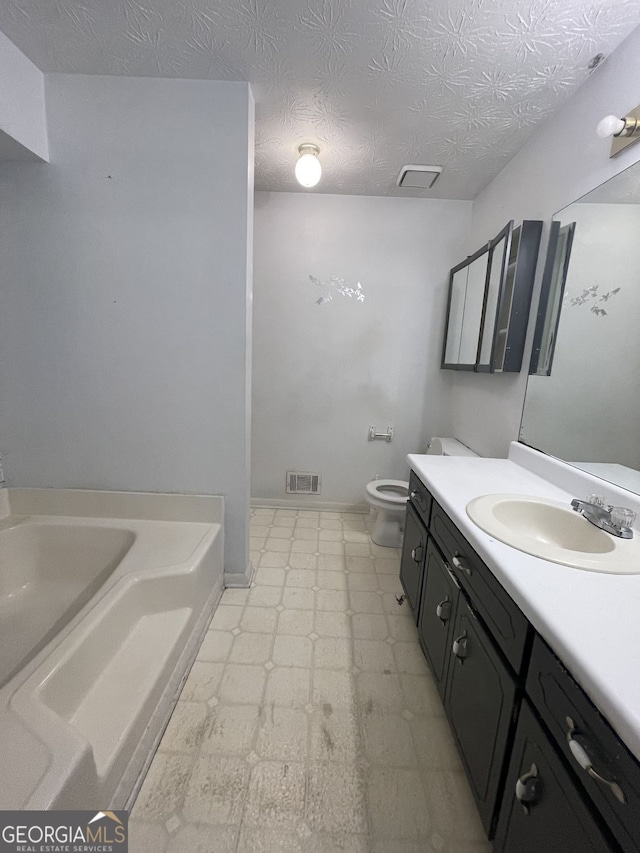 full bath with toilet, visible vents, vanity, a bath, and tile patterned floors