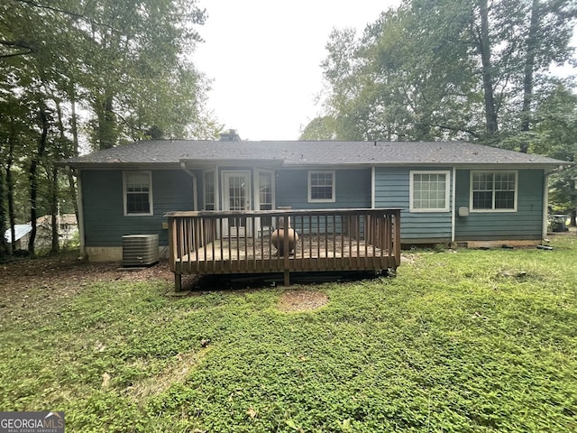 rear view of house featuring a deck, cooling unit, and a yard