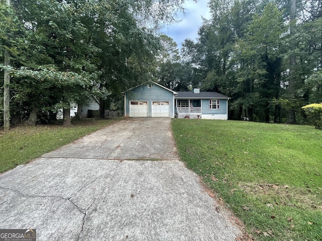 ranch-style house featuring an attached garage, a chimney, a front yard, and concrete driveway