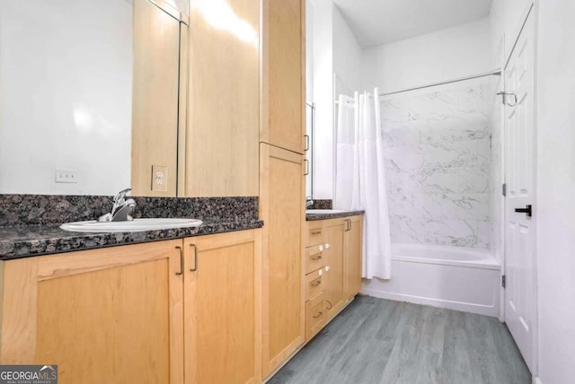 bathroom with vanity, hardwood / wood-style flooring, and shower / bath combo