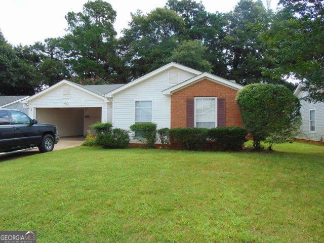 148 Lake Ter, Mcdonough, GA 30253 - ranch-style house featuring a front yard and a garage