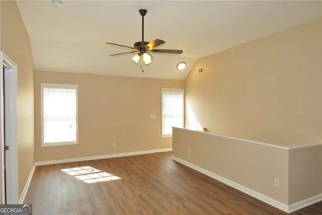 unfurnished room featuring ceiling fan, lofted ceiling, and dark hardwood / wood-style flooring