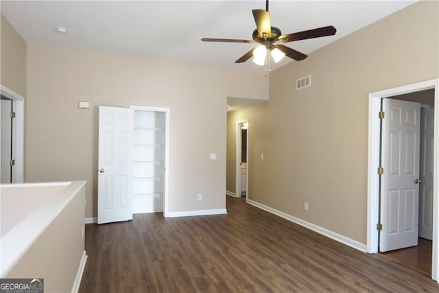 unfurnished bedroom featuring dark wood-type flooring and ceiling fan