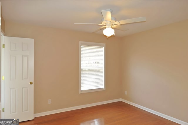 unfurnished room with ceiling fan and hardwood / wood-style flooring