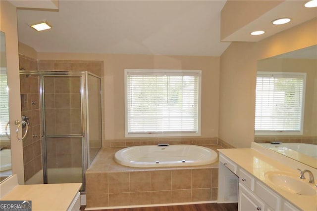 bathroom with vanity, shower with separate bathtub, and hardwood / wood-style flooring