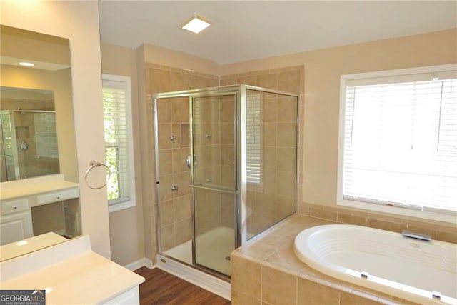 bathroom featuring vanity, hardwood / wood-style floors, and independent shower and bath