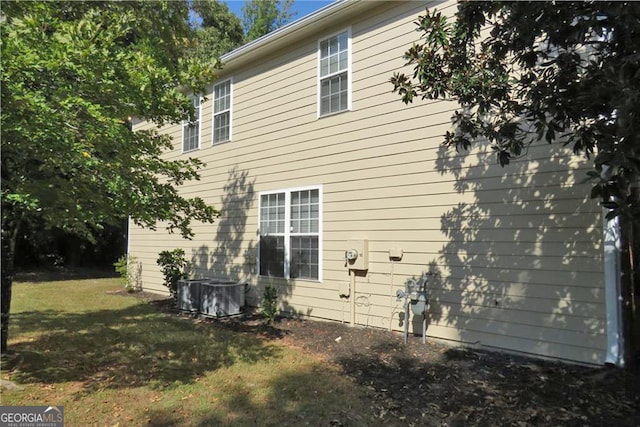 view of side of property with a lawn