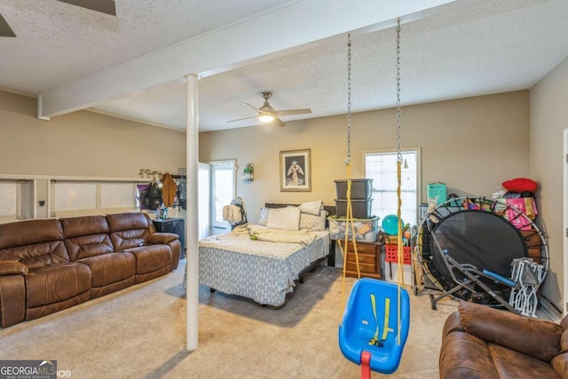 carpeted bedroom with a textured ceiling, beamed ceiling, and multiple windows