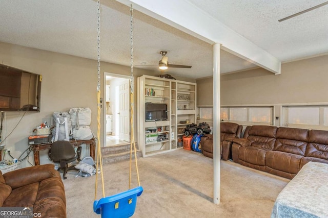 living room featuring beamed ceiling, a textured ceiling, carpet flooring, and ceiling fan