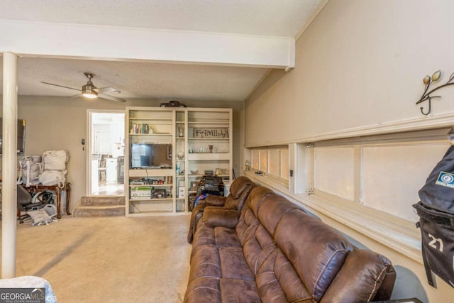 living room featuring ceiling fan, a textured ceiling, carpet floors, and vaulted ceiling with beams