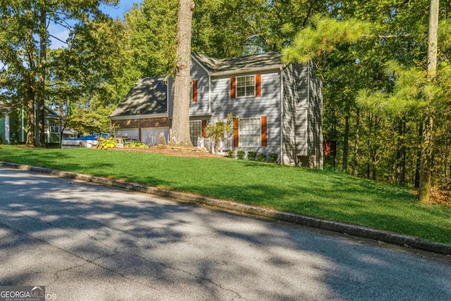 view of side of property with a lawn