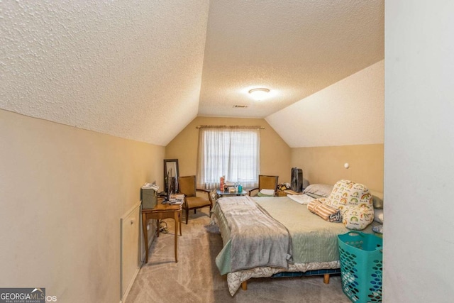 carpeted bedroom with a textured ceiling and lofted ceiling