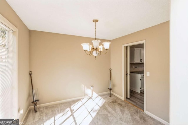 interior space featuring carpet floors and an inviting chandelier