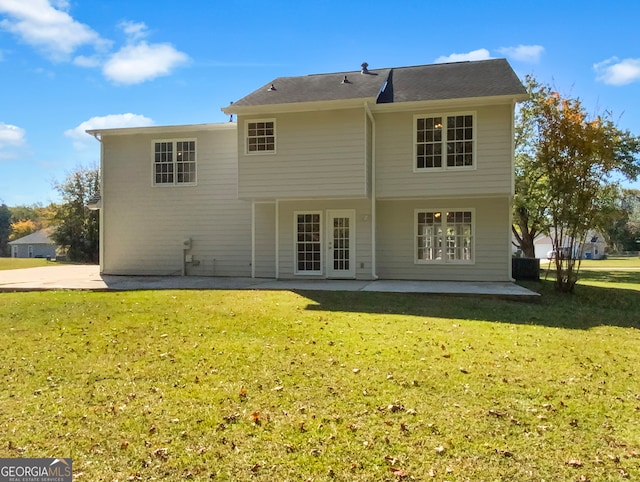 rear view of house featuring french doors, a yard, and a patio area