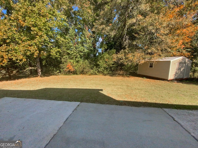 view of yard with a shed and a patio area