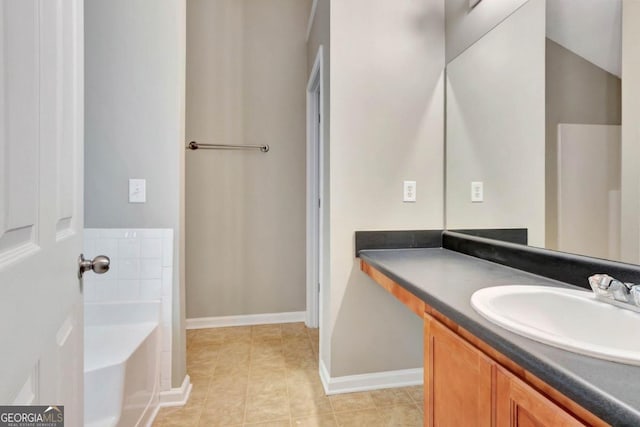 bathroom with vanity, tile patterned flooring, and a bathing tub