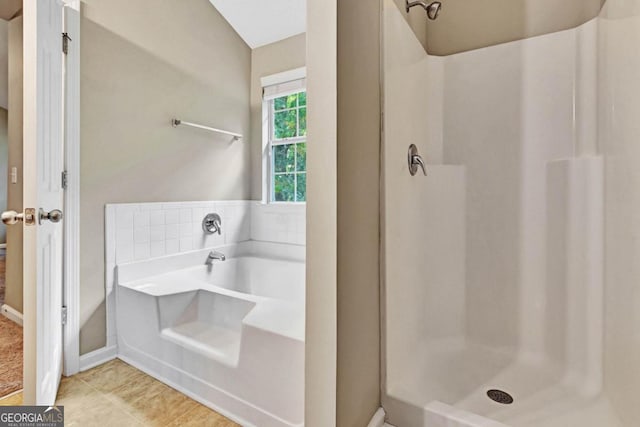 bathroom featuring tile patterned floors and separate shower and tub