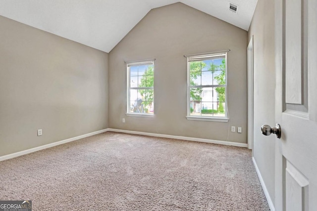 unfurnished room with carpet floors and vaulted ceiling