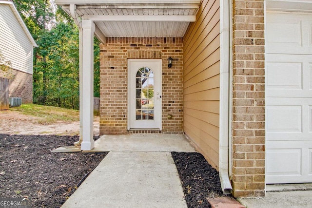 doorway to property with cooling unit and a garage