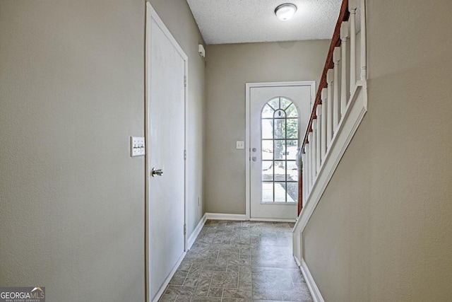 doorway featuring a textured ceiling