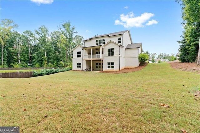 rear view of property featuring a lawn and a balcony