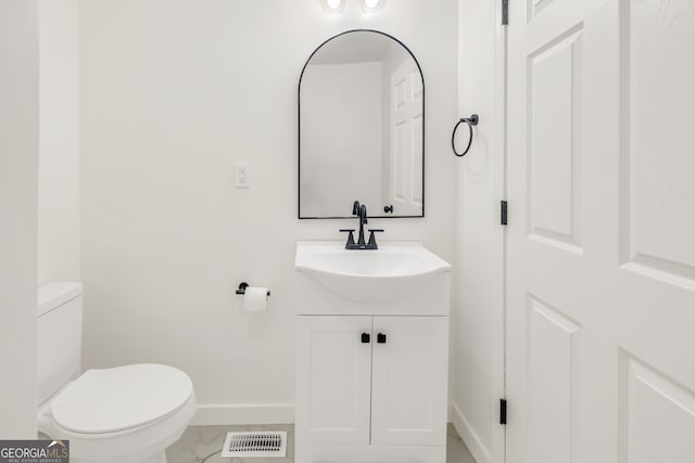 bathroom with vanity and toilet