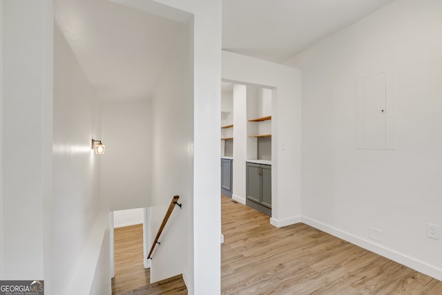 hall with electric panel and light wood-type flooring