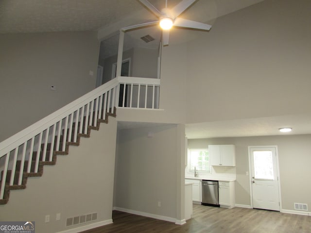 stairs with vaulted ceiling and hardwood / wood-style flooring