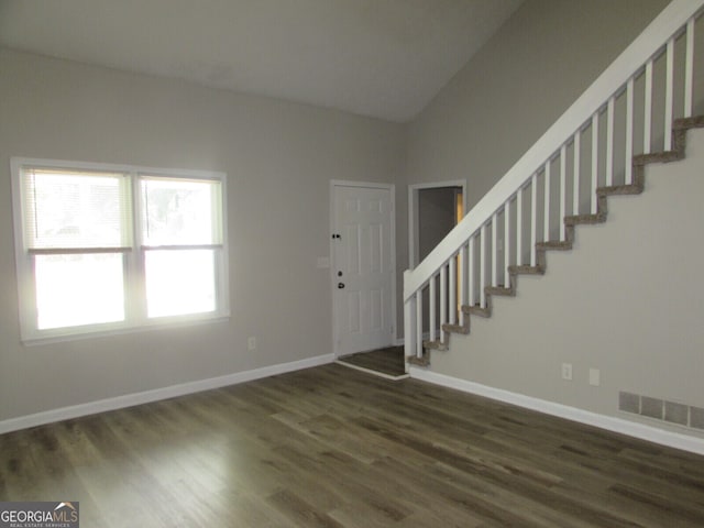 foyer featuring lofted ceiling and dark hardwood / wood-style floors