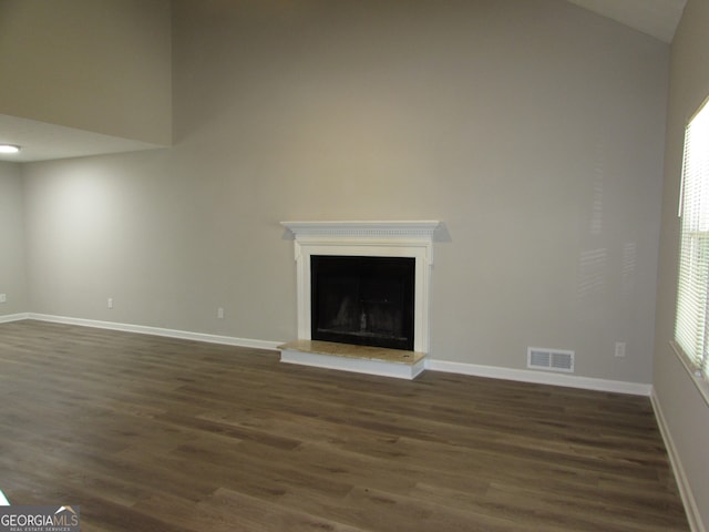 unfurnished living room with dark hardwood / wood-style floors and high vaulted ceiling